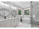 Bright bathroom with double vanity, soaking tub, tiled shower, and elegant fixtures at 12301 Hardee Rd, Raleigh, NC 27614