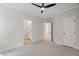 Bedroom with a ceiling fan, carpet, and an open doorway to a bathroom at 12301 Hardee Rd, Raleigh, NC 27614