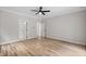 Bedroom with a ceiling fan, hardwood floors, and a view of the hallway at 12301 Hardee Rd, Raleigh, NC 27614