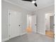 Bedroom with a ceiling fan, carpet, and an open doorway to a bathroom at 12301 Hardee Rd, Raleigh, NC 27614