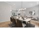 Dining room with modern lighting, hardwood floors, and view of the living room at 12301 Hardee Rd, Raleigh, NC 27614