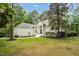 Beautiful white brick home featuring lush lawn and walkway to the front door at 12301 Hardee Rd, Raleigh, NC 27614