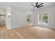 Bright living room with hardwood floors, large windows, and modern ceiling fan at 12301 Hardee Rd, Raleigh, NC 27614