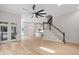 Open living space with hardwood floors, modern fan, and view of kitchen at 12301 Hardee Rd, Raleigh, NC 27614