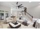 Open-concept living area showcasing staircase and view of the dining area and kitchen at 12301 Hardee Rd, Raleigh, NC 27614