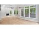 Bright living room with fireplace, large windows, and a modern ceiling fan at 12301 Hardee Rd, Raleigh, NC 27614