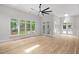 Bright living room with hardwood floors, large windows and doors to the backyard at 12301 Hardee Rd, Raleigh, NC 27614