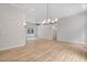 Spacious living room with hardwood floors, modern light fixtures, and large windows at 12301 Hardee Rd, Raleigh, NC 27614