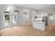 Bright, open-concept living space with modern kitchen, white cabinets, stainless appliances, and access to the outdoor deck at 12301 Hardee Rd, Raleigh, NC 27614