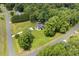 Aerial view of a home surrounded by mature trees, a yard, and a private driveway at 133 Creekstone Dr, Benson, NC 27504
