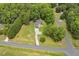 Aerial view of a home surrounded by a yard and mature trees and with a storage shed in the back at 133 Creekstone Dr, Benson, NC 27504