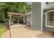 View of the home's back deck with wood pergola, grill, and table perfect for outdoor entertaining at 133 Creekstone Dr, Benson, NC 27504