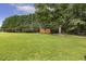 Sprawling backyard with a storage shed and mature trees at 133 Creekstone Dr, Benson, NC 27504