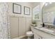 Charming bathroom featuring a granite vanity, framed art, and a shower with a patterned curtain at 133 Creekstone Dr, Benson, NC 27504