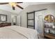 Bright bedroom with vaulted ceiling, ceiling fan, and ensuite bathroom with sliding barn door at 133 Creekstone Dr, Benson, NC 27504