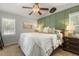 Comfortable bedroom boasts a ceiling fan, a decorative wall, and a plush king-sized bed for a relaxing atmosphere at 133 Creekstone Dr, Benson, NC 27504