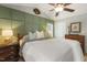 This comfortable bedroom features a decorative wall, a ceiling fan, and natural light from a window at 133 Creekstone Dr, Benson, NC 27504