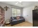 Functional bedroom featuring a comfortable sofa, closet, and natural light, perfect for relaxing and storage at 133 Creekstone Dr, Benson, NC 27504