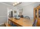Bright dining room featuring a wooden table, decorative centerpiece, and views of the living room and kitchen at 133 Creekstone Dr, Benson, NC 27504