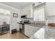 Classic kitchen boasts white cabinets, subway tile backsplash, granite counters and modern appliances at 133 Creekstone Dr, Benson, NC 27504