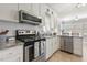 Updated kitchen features stainless steel appliances, white cabinets and a charming breakfast bar at 133 Creekstone Dr, Benson, NC 27504