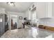 Bright kitchen with granite countertops, white cabinets, and stainless steel appliances offer a modern touch at 133 Creekstone Dr, Benson, NC 27504