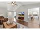 Open living area with wood floors, a TV, and a view into the dining area at 133 Creekstone Dr, Benson, NC 27504