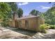 Backyard view showing a brick house with mature trees at 136 Sycamore St, Cary, NC 27513