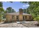 Backyard view showing a brick house with a mature chimney at 136 Sycamore St, Cary, NC 27513