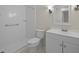 Well-lit bathroom featuring a white vanity, toilet, and shower at 136 Sycamore St, Cary, NC 27513