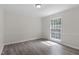Bright bedroom with natural light, wood-look floors, and classic chair rail molding at 136 Sycamore St, Cary, NC 27513