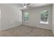 Bedroom featuring neutral carpet, ceiling fan, and two windows at 136 Sycamore St, Cary, NC 27513