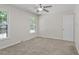 Spacious bedroom with neutral carpeting, ceiling fan and lots of natural light at 136 Sycamore St, Cary, NC 27513