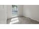 This bedroom features neutral walls, plush carpeting, and a large window for natural light at 136 Sycamore St, Cary, NC 27513