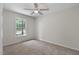 This bedroom features neutral walls, plush carpeting, and a ceiling fan at 136 Sycamore St, Cary, NC 27513