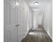 Hallway with wood-look floors and white doors leading to various rooms in the home at 136 Sycamore St, Cary, NC 27513
