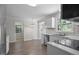 Bright kitchen featuring white cabinets, stainless steel appliances and marble countertops at 136 Sycamore St, Cary, NC 27513