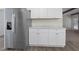 Kitchen featuring stainless steel refrigerator and white cabinets at 136 Sycamore St, Cary, NC 27513