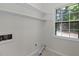 Laundry room with ample lighting, shelving and a large window at 136 Sycamore St, Cary, NC 27513