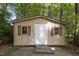 Exterior view of the wooden shed, with wood shutters and a concrete foundation at 136 Sycamore St, Cary, NC 27513