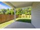 Covered back porch overlooking a private backyard with a wooden fence and young trees at 1401 Justice Union Ct, Raleigh, NC 27604