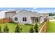 View of fenced backyard with raised garden beds and covered porch at 1401 Justice Union Ct, Raleigh, NC 27604