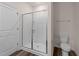 Bathroom featuring a stand-up shower with sliding glass doors and modern fixtures at 1401 Justice Union Ct, Raleigh, NC 27604