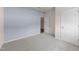 Bedroom with light blue accent wall, neutral carpet, and a closet at 1401 Justice Union Ct, Raleigh, NC 27604