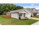 Charming home with a well-maintained lawn, fenced yard, and an attached garage at 1401 Justice Union Ct, Raleigh, NC 27604