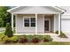 View of a well-manicured lawn with a front porch and decorative columns at 1401 Justice Union Ct, Raleigh, NC 27604