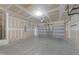 Spacious garage features concrete flooring, an automatic door, and ample ceiling storage at 1401 Justice Union Ct, Raleigh, NC 27604