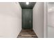 View of the foyer entry way with a wooden floor and dark green door with a dark green ceiling at 1401 Justice Union Ct, Raleigh, NC 27604