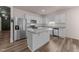 Bright kitchen featuring stainless steel appliances, granite countertops, and a center island with wood flooring at 1401 Justice Union Ct, Raleigh, NC 27604