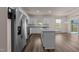 Bright kitchen featuring stainless steel appliances, granite countertops, a center island, and a connecting dining area at 1401 Justice Union Ct, Raleigh, NC 27604
